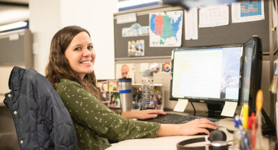 Woman smiling while sitting at her desk