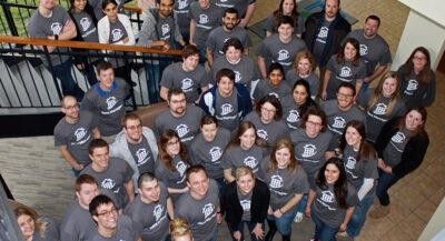Group of LCS employees wearing LCS shirts pose for group photo