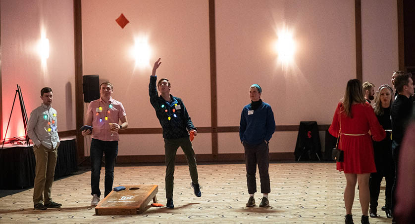 People playing cornhole at LCS Holiday Party