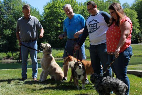 Several LCS Employees with their dogs outside the office