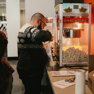 An LCS employee enjoying popcorn in the office during fun at work week