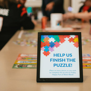 A sign that reads "help us finish the puzzle" in the LCS office during fun at work week