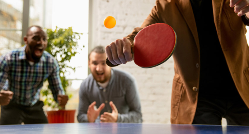 Employee Engagement Ideas - Employees playing table tennis