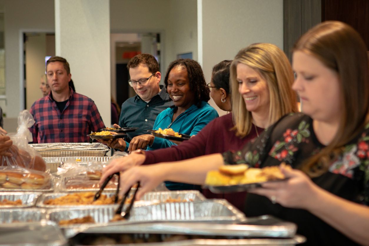 LCS Employees enjoying food at the office