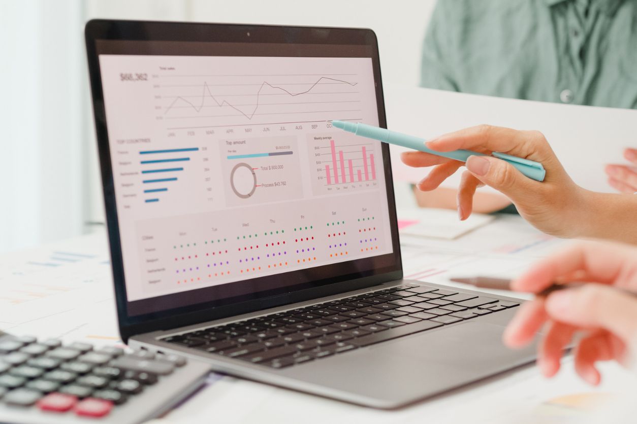 Closeup group of Asian business people meeting discuss project plan and financial results in office. Marketing strategy analysis, stock market trading, financial consultant concept.