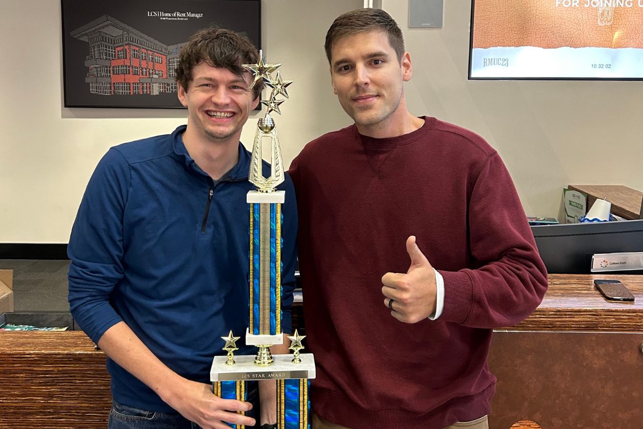 LCS Employees posing with a Trophy